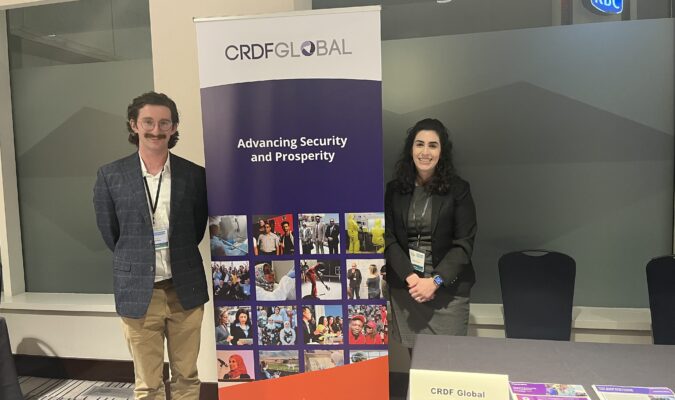 2 people in front of a banner